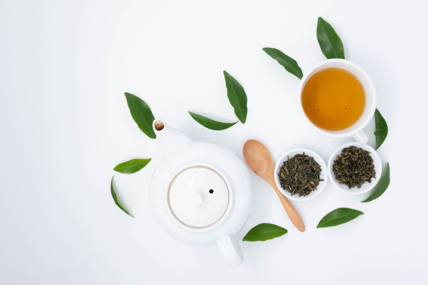 A tea set with fresh green leaves