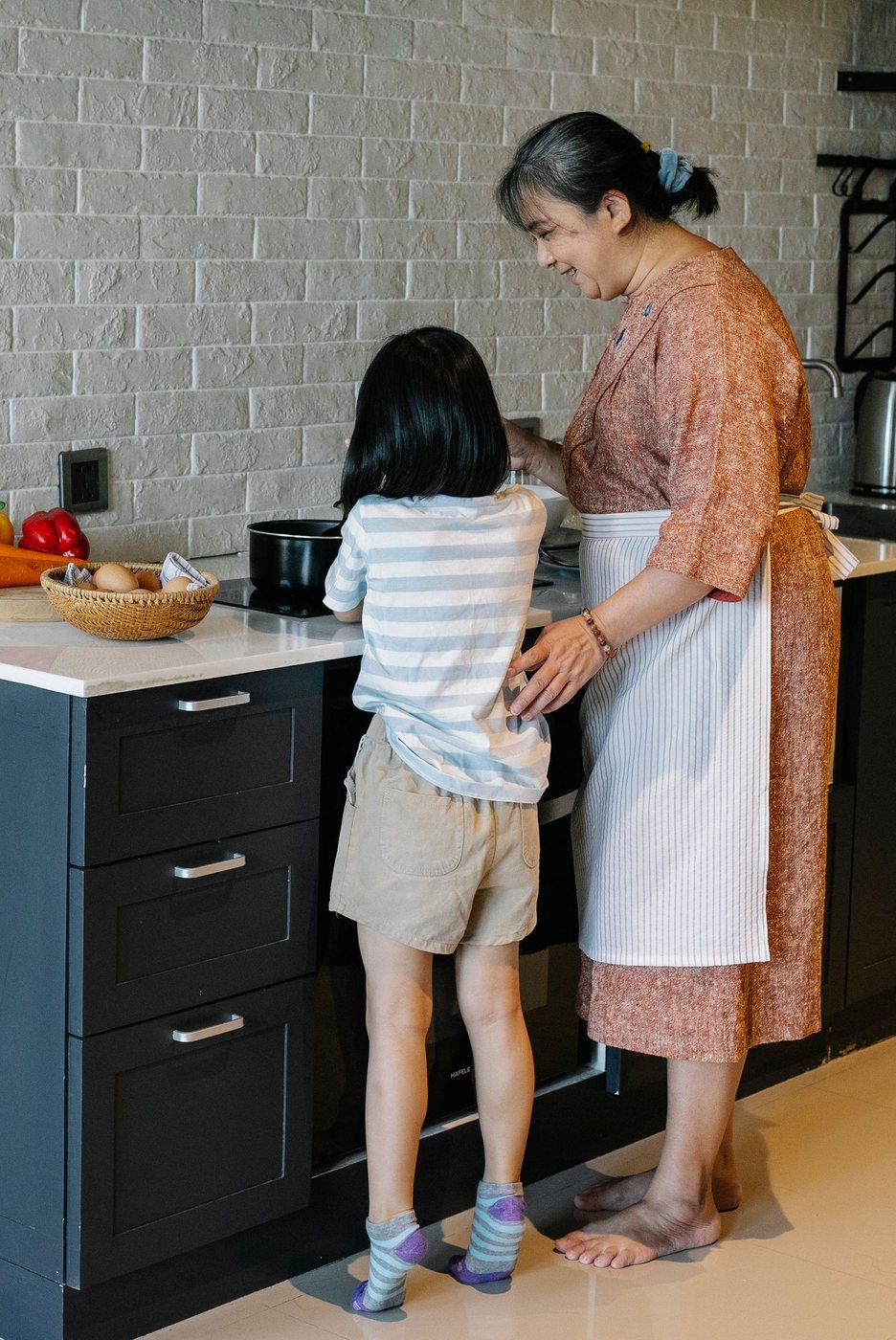 A grandmother and child cooking together